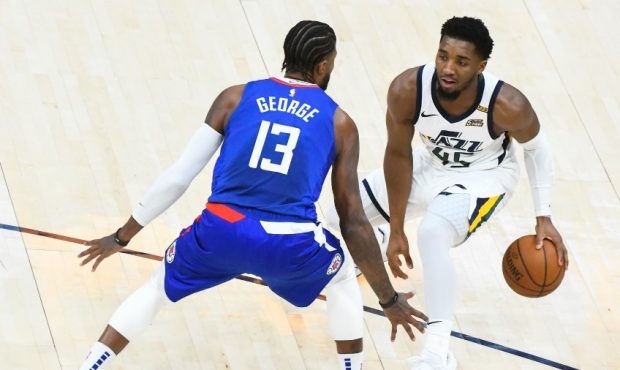 Donovan Mitchell of the Utah Jazz goes against the Los Angeles Clippers Paul George (Photo by Alex ...