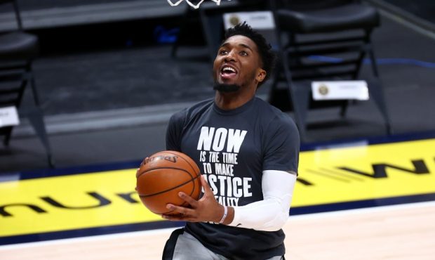 Donovan Mitchell warms up wearing a shooting shirt with a quote from Dr. Martin Luther King Jr. (Ph...