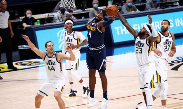 The Utah Jazz and the Denver Nuggets fight for a rebound (Photo by Jamie Schwaberow/Getty Images)...