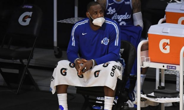 Los Angeles Lakers star LeBron James wears a mask on the sidelines (Photo by John McCoy/Getty Image...