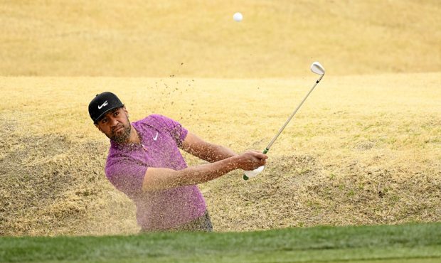 Tony Finau plays a shot from a bunker on the eighth hole during the third round of The American Exp...