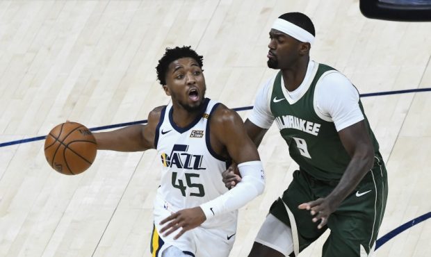 Donovan Mitchell of the Utah Jazz drives against Bobby Portis of the Milwaukee Bucks. (Photo by Ale...