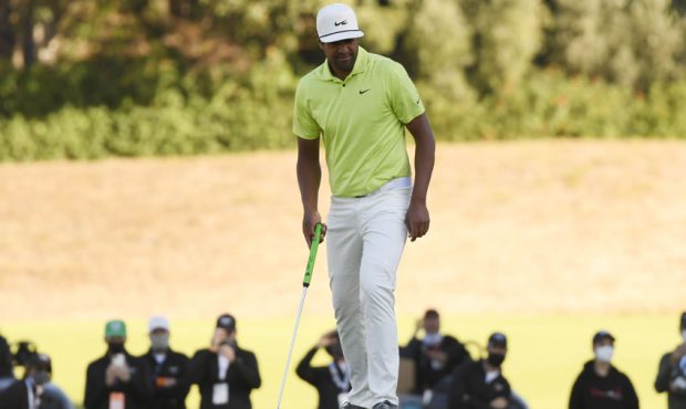 Tony Finau of the United States reacts after missing a putt on the 14th green in a playoff against ...