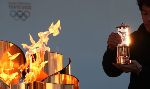 IWAKI, JAPAN - MARCH 25: A staff preserves the Olympic flame to the lantern during the 'Flame of Re...