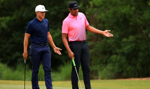 Tony Finau and Cameron Champ talk over a shot on the fourth green during the second round of the Zu...