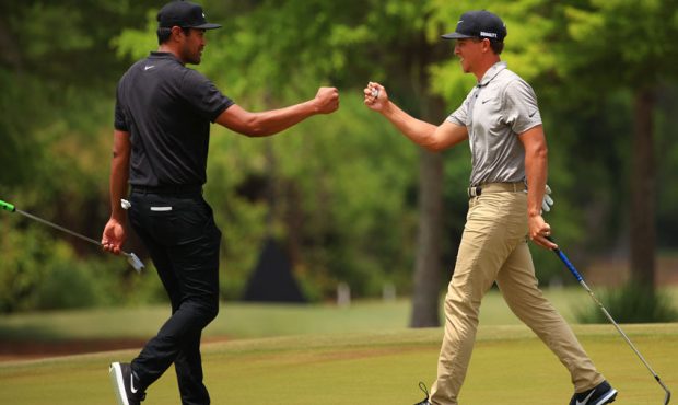 Tony Finau and Cameron Champ react after a putt on the sixth green during the third round of the Zu...