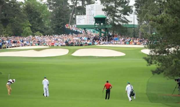 Tony Finau of the United States plays a second shot on the seventh hole as Tiger Woods of the Unite...