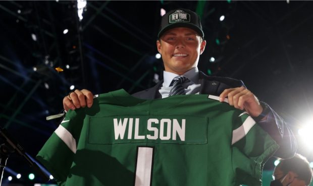 Zach Wilson holds New York Jets jersey at NFL Draft...