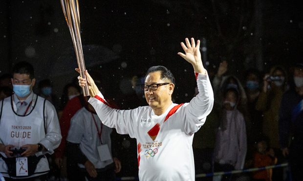 TOYOTA, JAPAN - APRIL 06: Toyota Motor Co President Akio Toyoda runs with the Olympic torch during ...