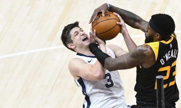 Utah Jazz forward Royce O'Neale gets tied up with Memphis Grizzlies guard Grayson Allen (Photo by A...