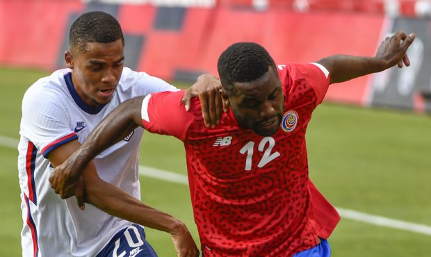 Joel Campbell #12 of Costa Rica controls the ball in front of Reggie Cannon #20 of the United State...