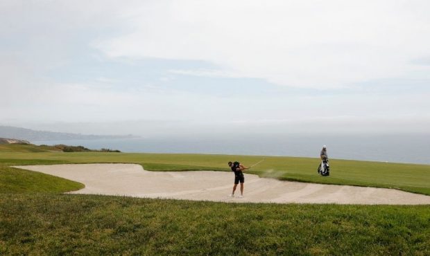 Charl Schwartzel of South Africa plays a shot from a bunker on the fourth hole during a practice ro...
