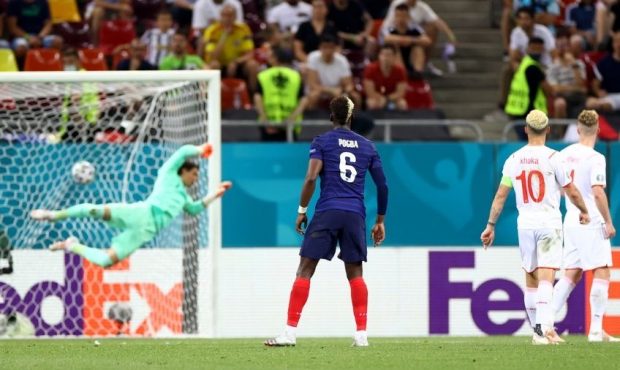 Paul Pogba of France scores their side's third goal past Yann Sommer of Switzerland...