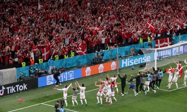 Players of Denmark celebrate in front of their fans following their side's victory in the UEFA Euro...