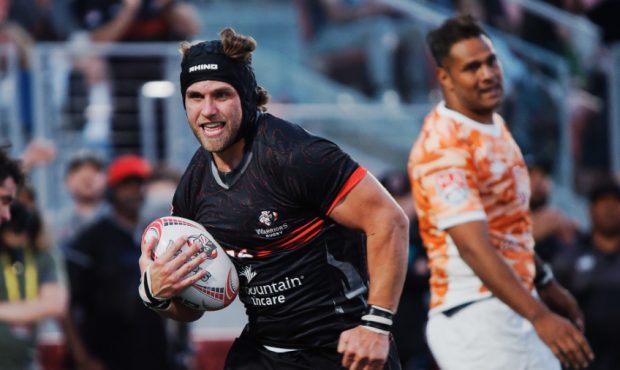 Utah Warriors player carries rugby ball...