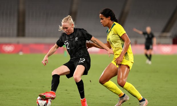 CHOFU, JAPAN - JULY 21: Betsy Hassett #12 of Team New Zealand battles for possession with Mary Fowl...