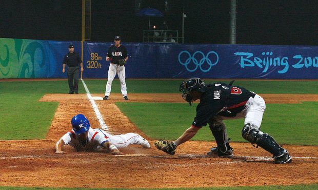 Keunwoo Jeong #8 of Korea scores the tying run under the tag of catcher Lou Marson #6 of the United...