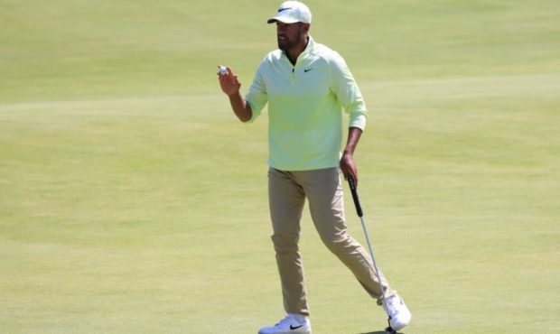 Tony Finau of the United States waves on the 18th green during Day Two of The 149th Open at Royal S...