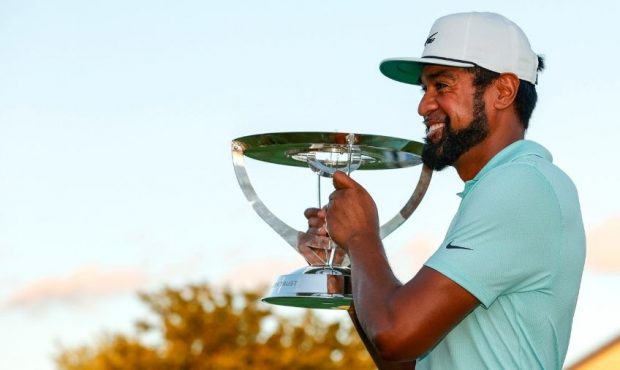 Tony Finau of the United States celebrates with the trophy after winning in a playoff during the fi...