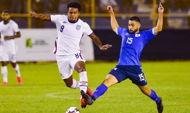 Weston McKennie (L) of the United States and Alex Roldan of El Salvador fight for the ball during a...
