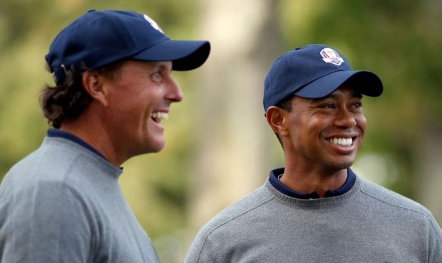 Tiger Woods and Phil Mickelson of the USA share a joke during the second preview day of The 39th Ry...