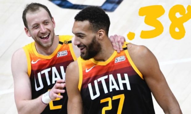Joe Ingles #2 and Rudy Gobert #27 of the Utah Jazz laugh during a game against the Orlando Magic at...