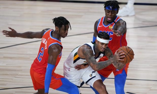 Utah Jazz guard Jordan Clarkson defended by Thunder guards Lu Dort and Shai Gilgeous-Alexander (Pho...