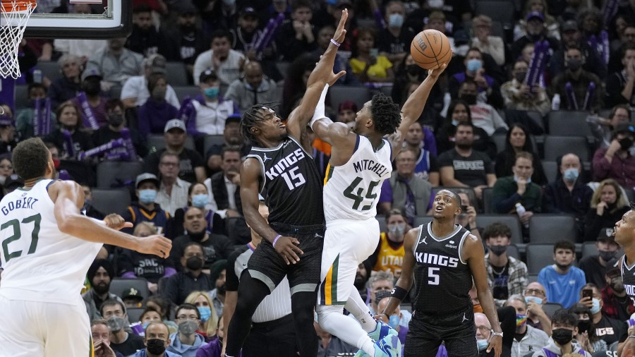 Utah Jazz guard Donovan Mitchell goes for a shot against Sacramento Kings guard Davion Mitchell (Ph...