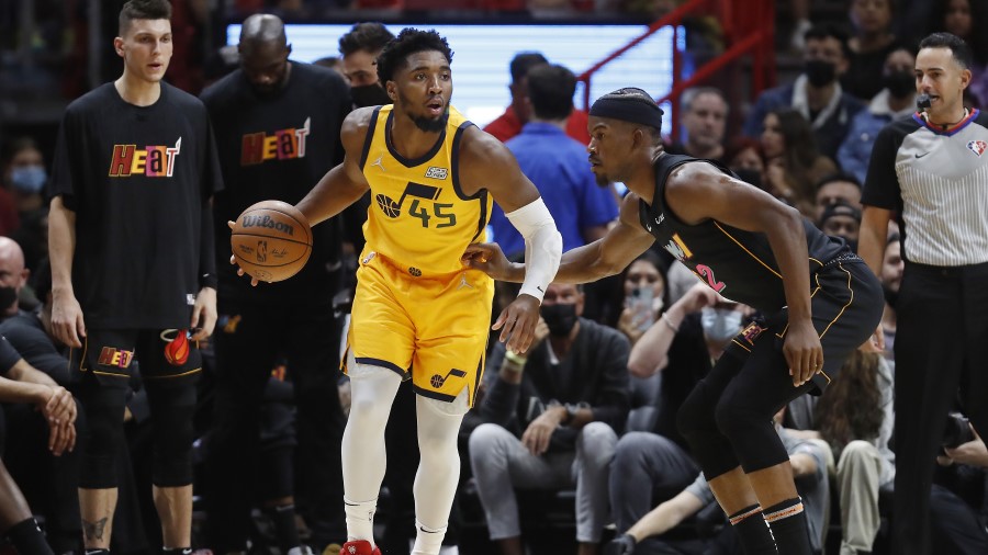 Utah Jazz guard Donovan Mitchell against Miami Heat guard Jimmy Butler (Photo by Michael Reaves/Get...