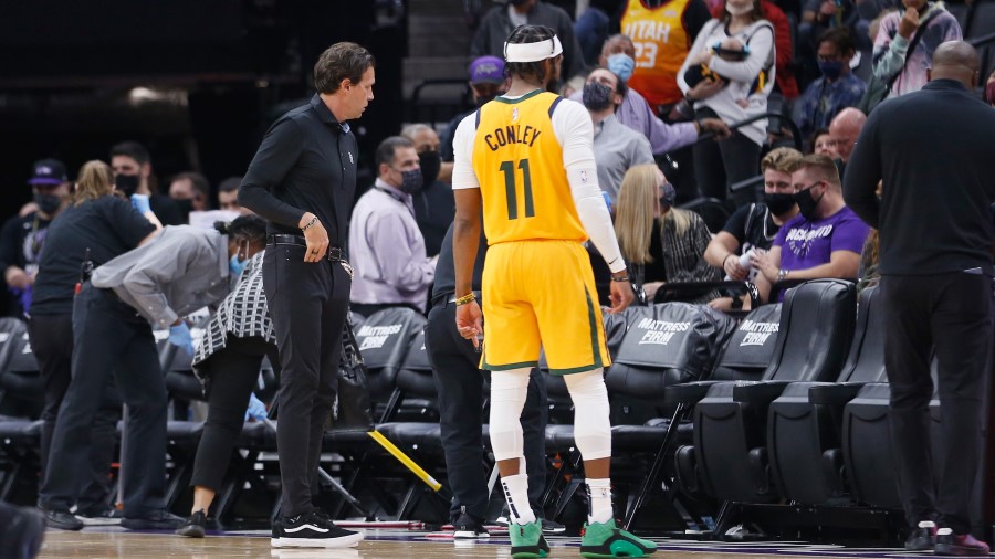 Utah Jazz coach Quin Snyder and Mike Conley look on as the Sacramento Kings cleaning crew clears vo...