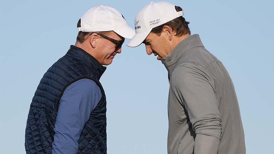 PEBBLE BEACH, CALIFORNIA - FEBRUARY 07: Former NFL players Peyton Manning and Eli Manning look on f...