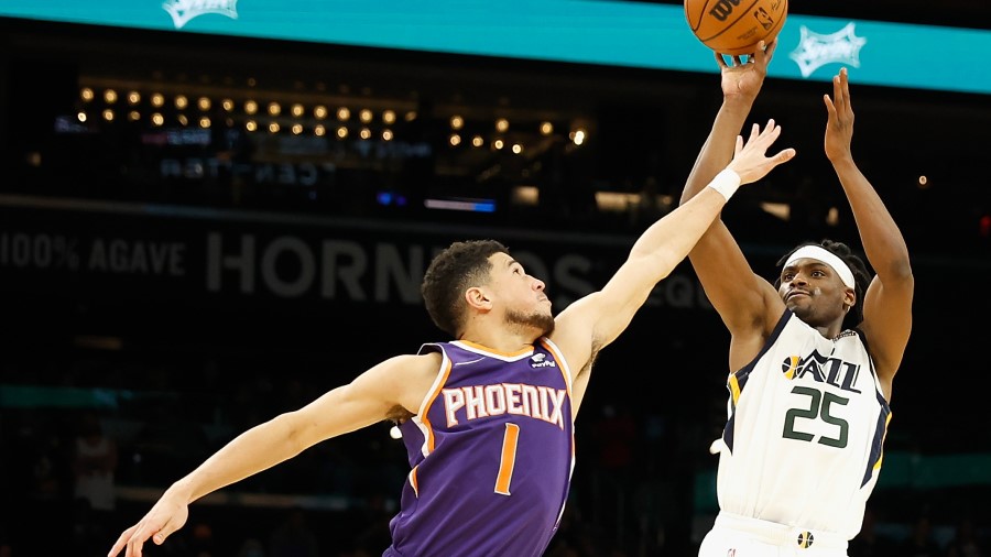 Utah Jazz guard Danuel House Jr. shoots over Phoenix Suns guard Devin Booker (Photo by Christian Pe...