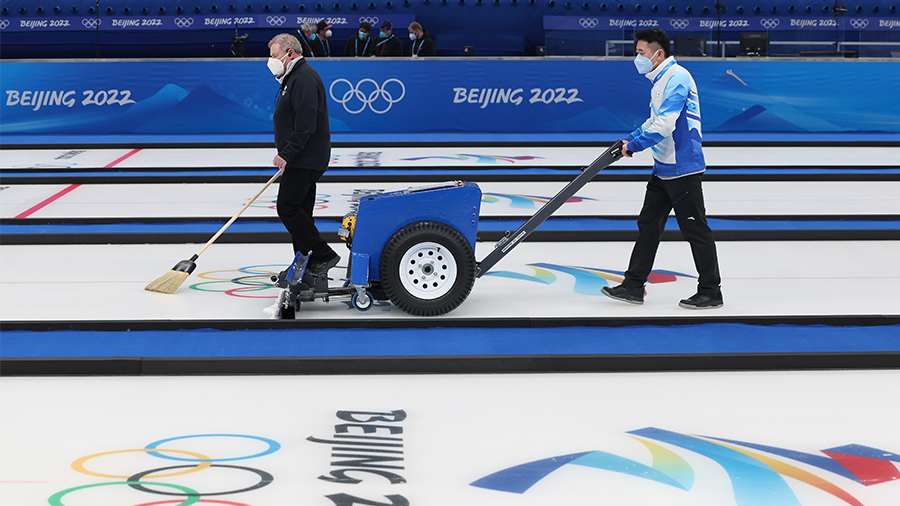 BEIJING, CHINA - FEBRUARY 02: Venue staff sweep the ice during a curling practice session ahead of ...