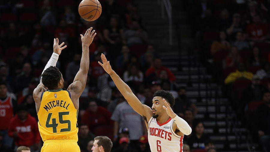 Utah Jazz guard Donovan Mitchell shoots over the Houston Rockets (Photo by Bob Levey/Getty Images)...