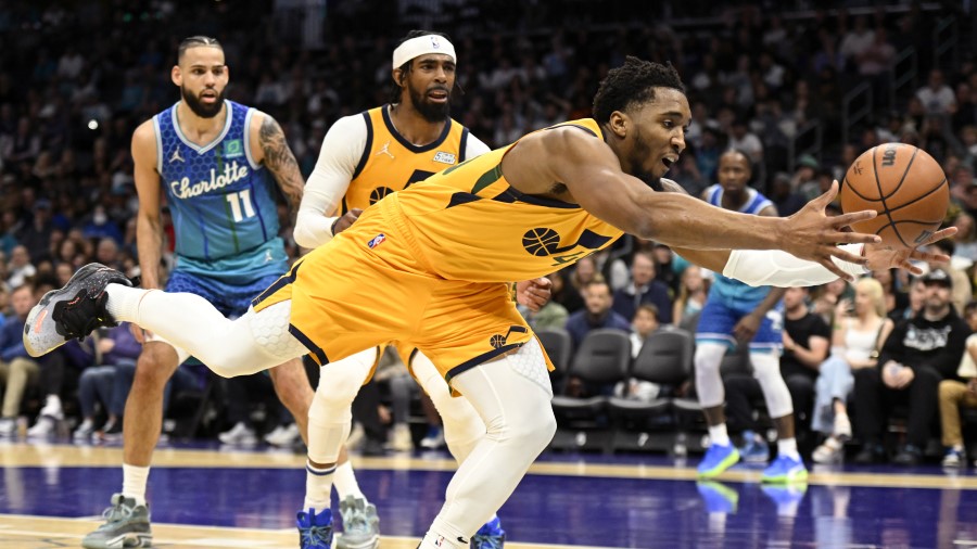 Utah Jazz guard Donovan Mitchell saves the ball against the Charlotte Hornets (Photo by Eakin Howar...