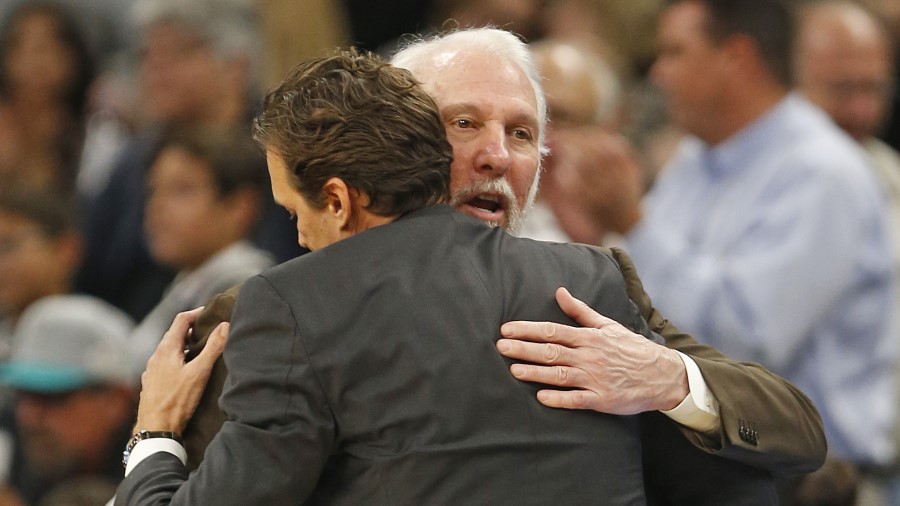 San Antonio Spurs head coach Gregg Popovich hugs Utah Jazz coach Quin Snyder (Photo by Ronald Corte...