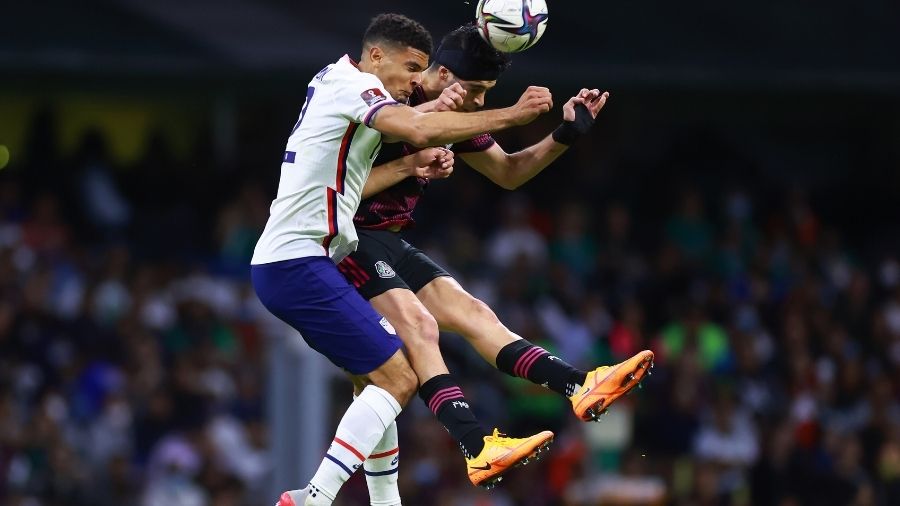 DeAndre Yedlin of United States heads the ball against Raul Jimenez of Mexico during a match betwee...
