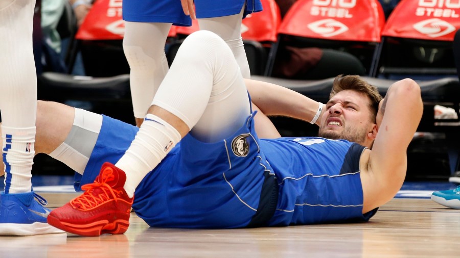 Dallas Mavericks guard Luka Doncic suffers and injury against the Utah Jazz (Photo by Tim Heitman/G...