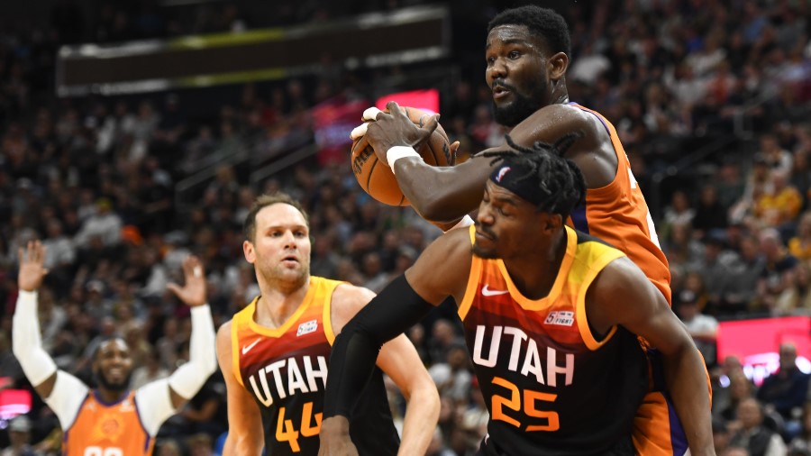 Phoenix Suns center DeAndre Ayton rebounds the ball over Utah Jazz forwards Danuel House Jr. and Bo...