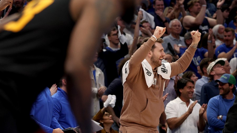 Dallas Mavericks guard Luka Doncic celebrates from the sidelines against the Utah Jazz (Photo by To...