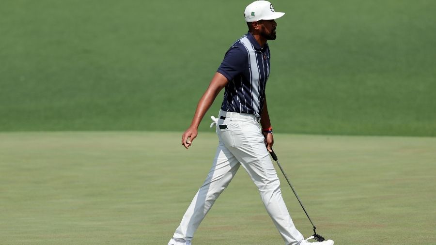 Tony Finau walks across the second green during the first round of the Masters at Augusta National ...