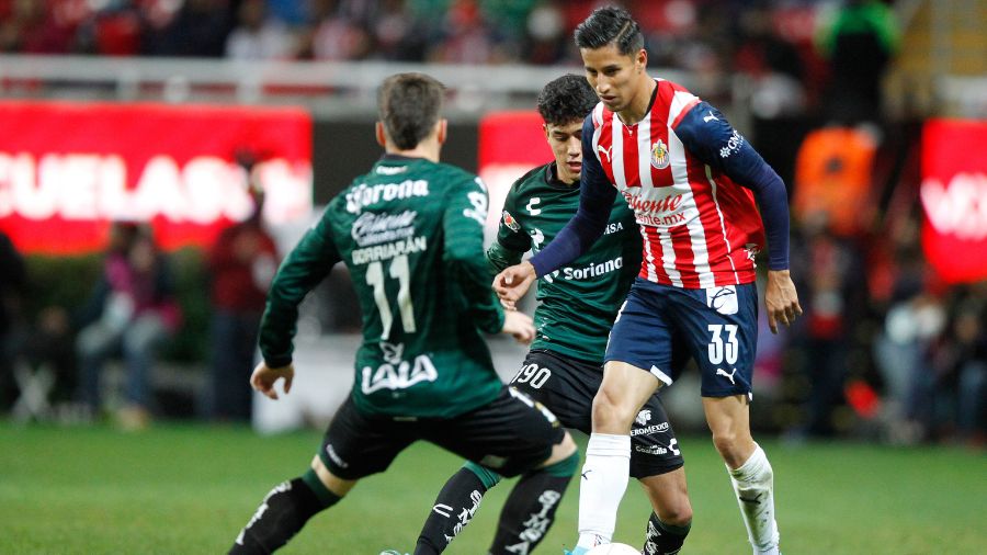 Carlos Cisneros of Chivas fights for the ball with Antonio Campos of Santos during the 9th round ma...