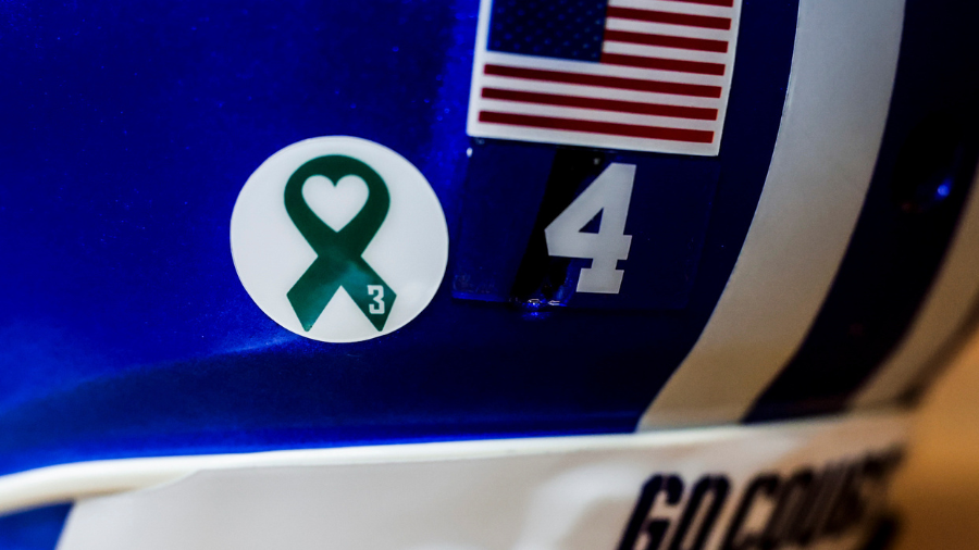 Greed ribbons worn on the helmets of BYU football players against Utah State on Thursday, September...