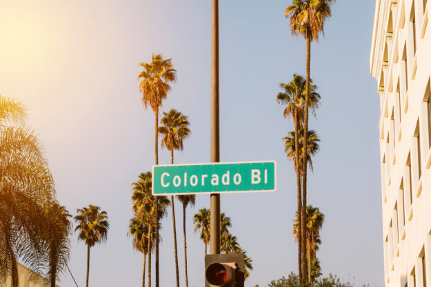 Colorado Blvd Street Sign with View of Palm Trees with Sky - Sunny Day - Pasadena - Los Angeles