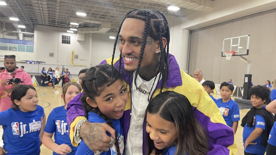 Utah Jazz guard Jordan Clarkson gets hugs from students at the Jr. NBA day event...