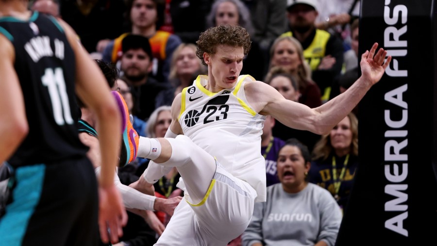 Utah Jazz forward Lauri Markkanen (23) falls hard to the floor after being fouled as the Jazz and t...