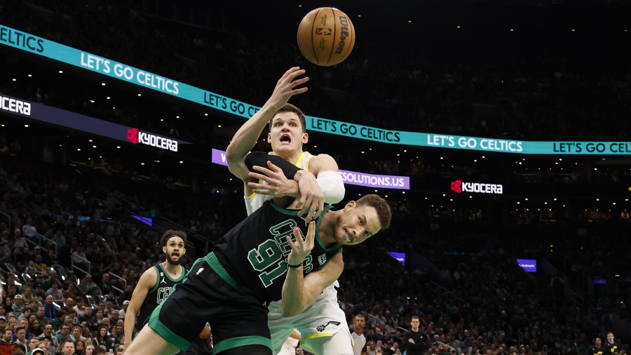 Walker Kessler #24 of the Utah Jazz goes over Blake Griffin #91 of the Boston Celtics...