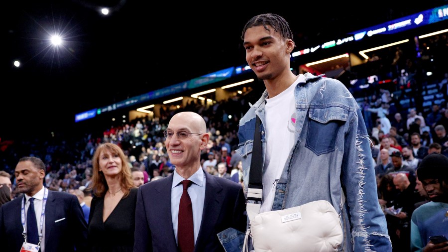 Adam Silver (L), Commissioner of the NBA poses for a photo with one of the top 2023 draft prospects...
