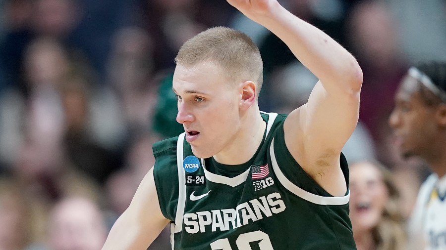Joey Hauser #10 of the Michigan State Spartans celebrates a three point basket against the Marquett...