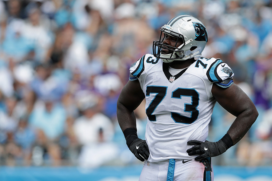 Michael Oher #73 of the Carolina Panthers watches a replay...